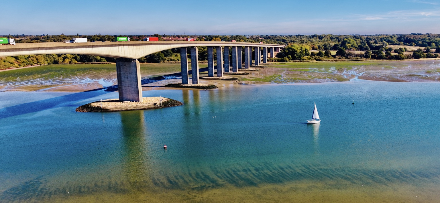 The Orwell Bridge and a sailing boat on the River Orwell